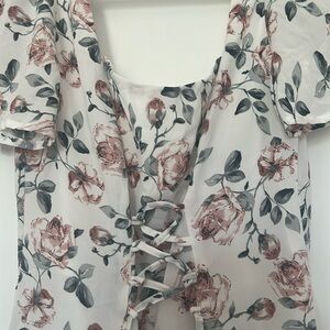 Dress is size small fits a size 2 midi dress that is a cream color with roses.